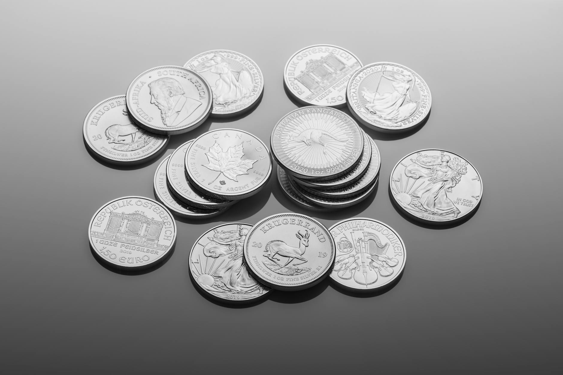 silver round coins on gray surface